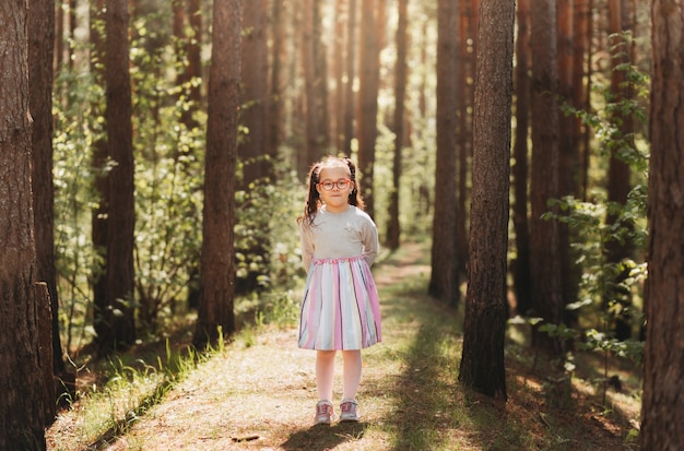 Premium Photo | A cute little girl in glasses in nature on a sunny day