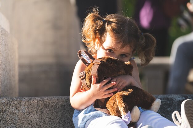 girl hugging stuffed animal