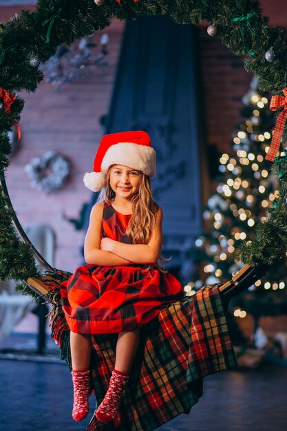 Free Photo | Cute little girl in santa hat and red dress