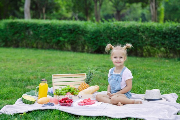 Cute Little Girl With Blonde Hair Sitting On The Park Photo