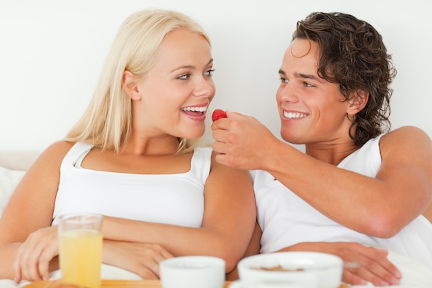 Premium Photo Cute Man Giving A Strawberry To His Girlfriend