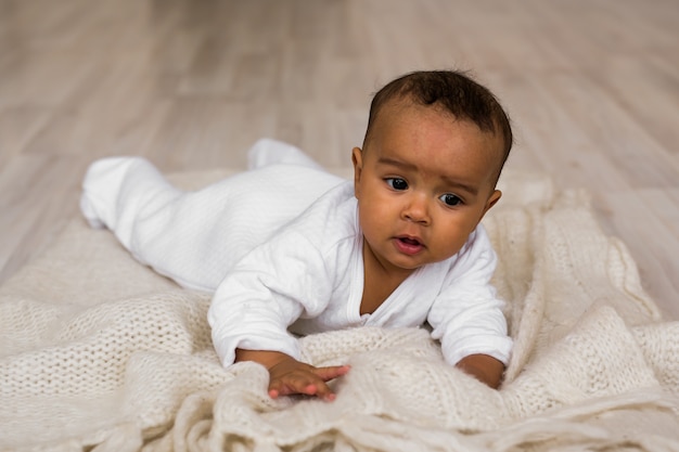 Premium Photo Cute Mixed Race African American Baby Boy Plays Inside On A Bed