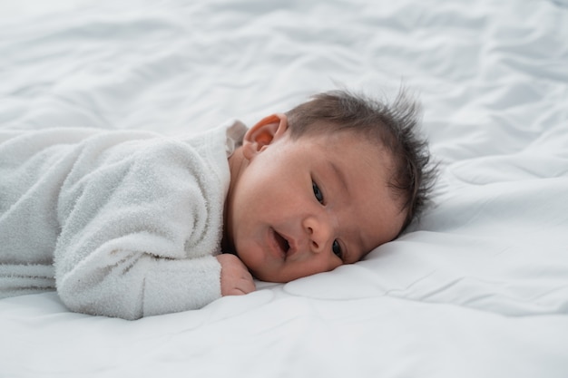 Premium Photo | Cute newborn baby laying on the bed