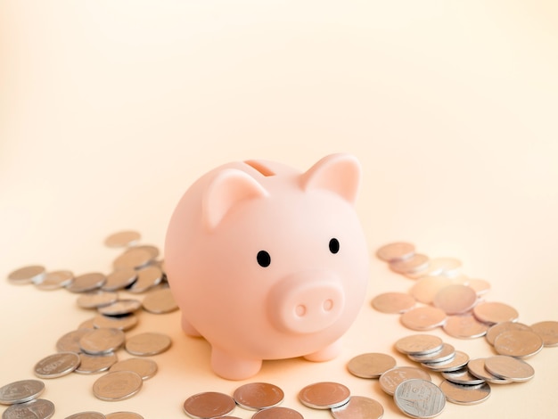 Premium Photo Cute Piggy Bank With Piles Of Thai Baht Coins On Soft Beige Surface