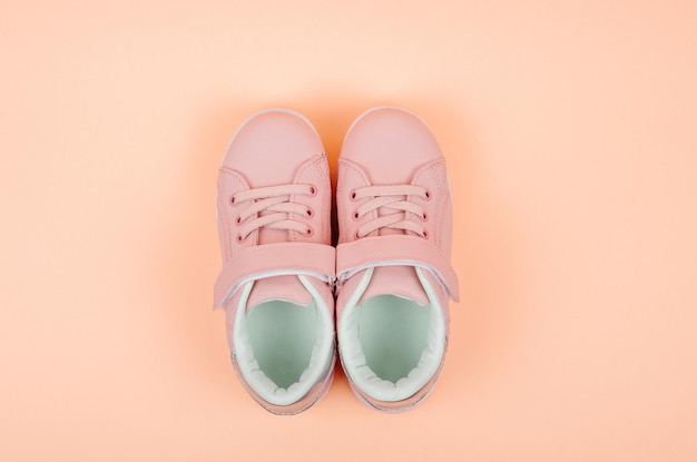 Premium Photo | Cute pink childrens sneakers orange background baby ...