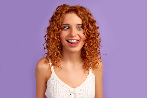 Premium Photo | Cute red-haired girl with curls funny sticking out her ...