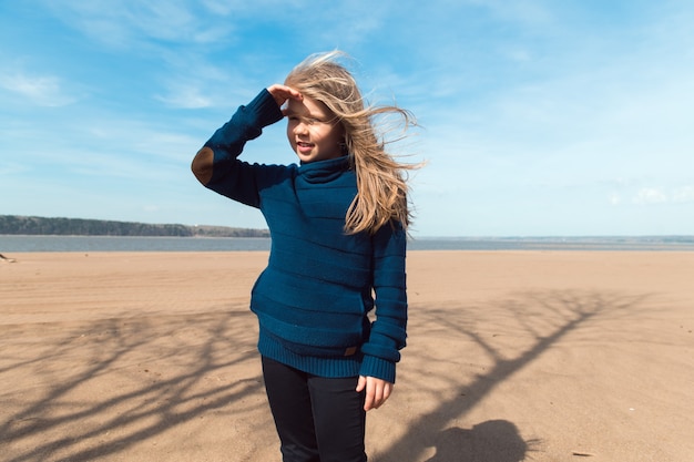 Premium Photo | Cute smiling girl on the beach in sunny day wint ...