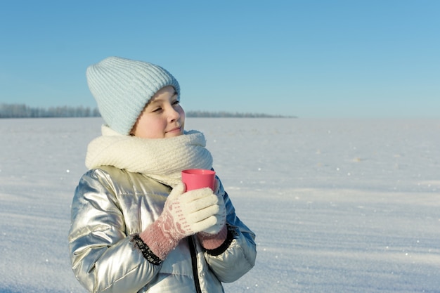 Premium Photo | Cute teen girl in winter clothes with cup of hot drink ...