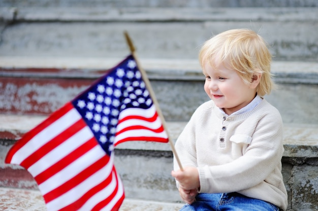 Premium Photo | Cute toddler boy holding american flag. independence ...