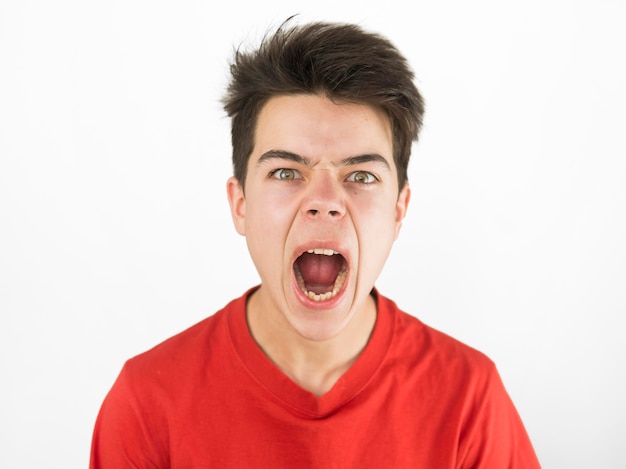 Cute young boy in red t-shirt being angry be Free Photo