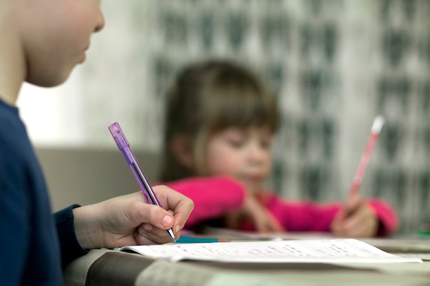 Premium Photo | Cute young children doing homeworks