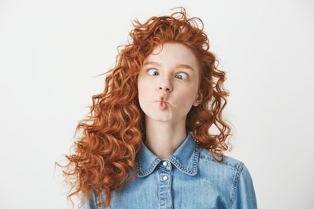 Free Photo Cute Young Girl With Foxy Curly Hair Making Funny Face Copy Space