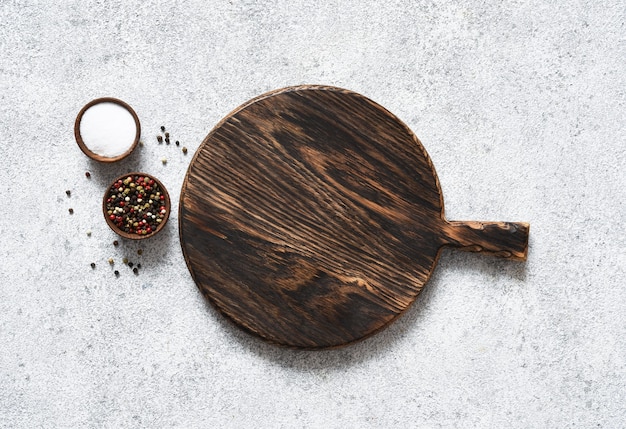 Premium Photo | Cutting board with rosemary and spices on ...