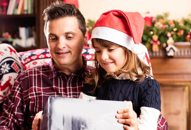 Dad and daughter opening a christmas gifts Photo | Free Download