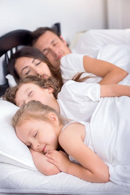 mom and dad sleeping with baby