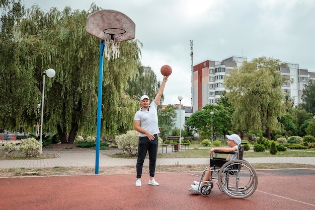 Premium Photo Dad Plays With His Disabled Son On The Sports Ground