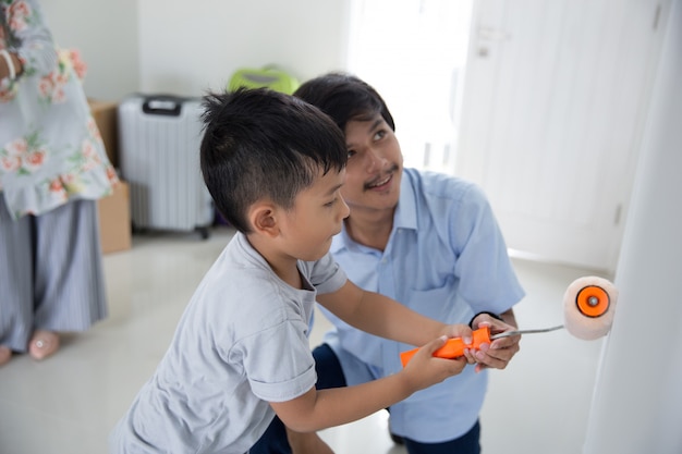 Premium Photo | Daddy and son paint their new house