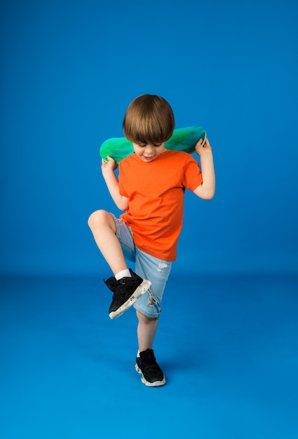 Premium Photo | Dancing boy with brown hair in an orange t-shirt and ...