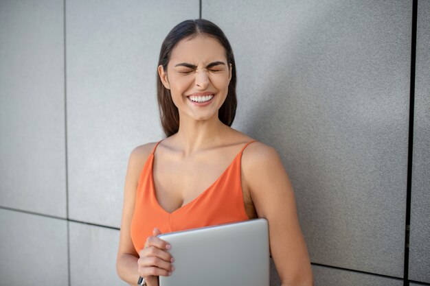 Premium Photo Dark Haired Pretty Woman With A Laptop Making Funny Face