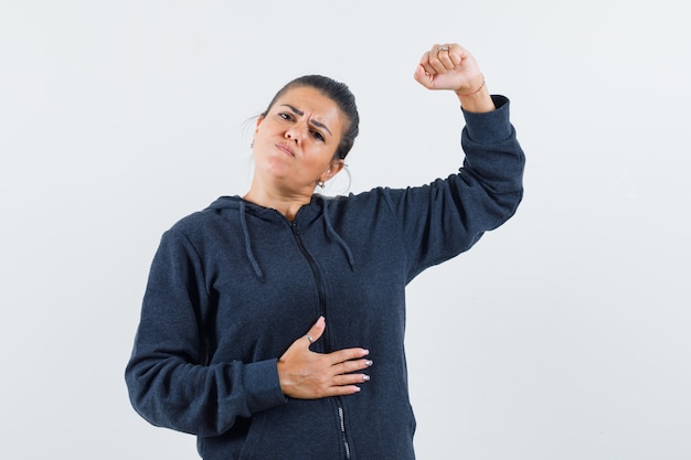 Free Photo | Dark-haired woman in jacket raising her arm and looking ...