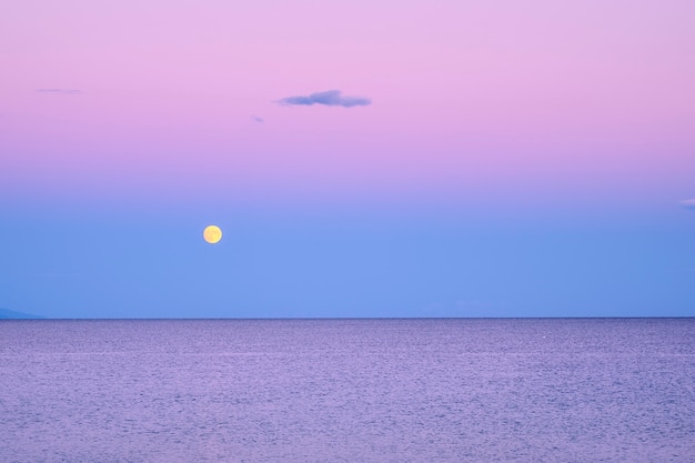 Premium Photo Dark Purple Sky With Yellow Moon Over Sea After Sunset In Greece