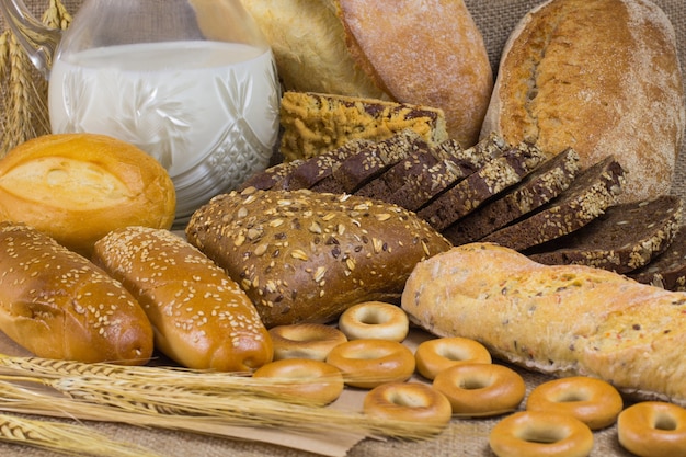 Premium Photo | Dark and white bread, milk and sticks of ...