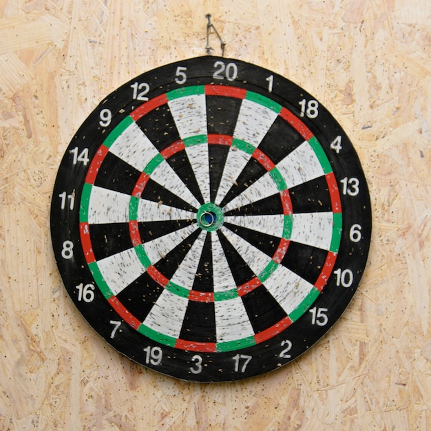 Dart arrow hitting in the target center of dartboard Premium Photo