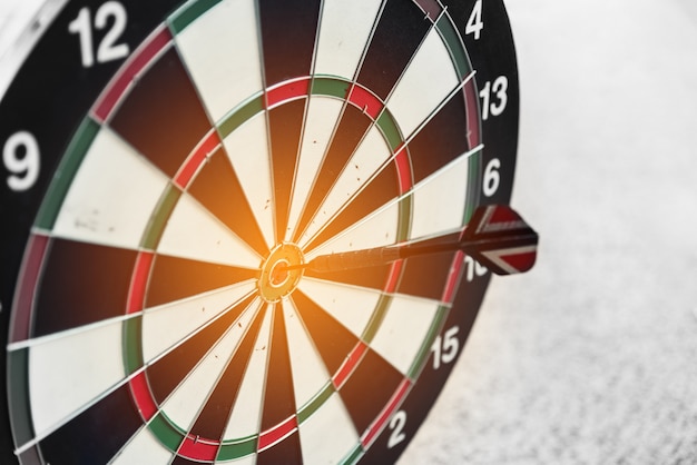 Premium Photo | Dart board and arrow in middle