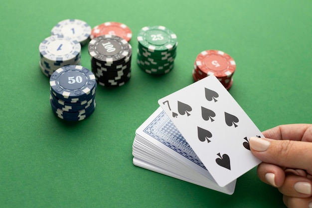 Premium Photo | Deck of cards and casino tokens on green background