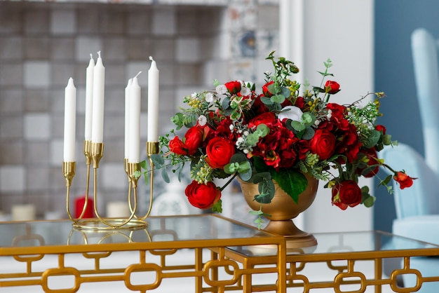 Premium Photo | Decor of candles in candlestick and vase with flowers..