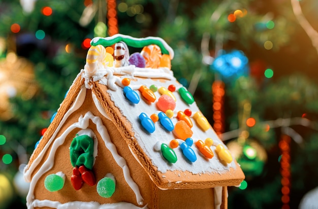 Premium Photo | Decorated gingerbread house on christmas tree surface