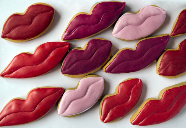 Premium Photo | Decorated lips shaped cookies on white