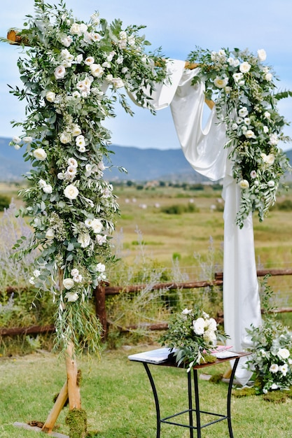Free Photo | Decorated wedding arch with greenery and white eustomas in ...