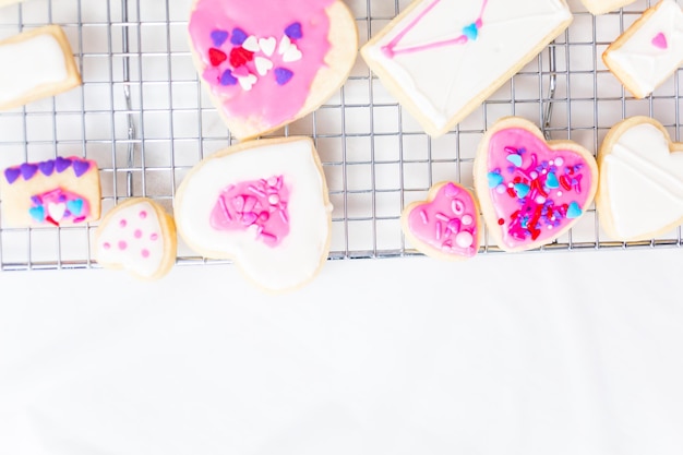 Premium Photo | Decorating heart shape sugar cookies with royal icing ...