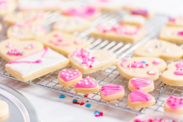 Premium Photo | Decorating heart shape sugar cookies with royal icing ...