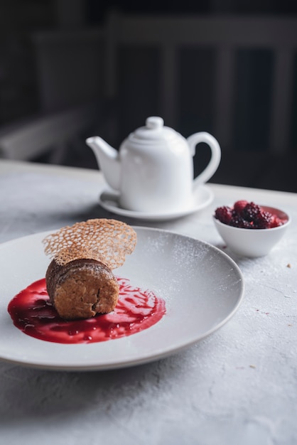 Decorative Dessert With Red Berries Sauce On White Ceramic