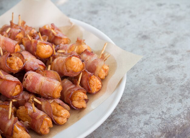 Premium Photo | Deep fried sausages rolled in bacon