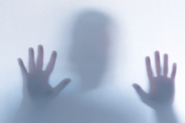 Premium Photo Defocused Scary Ghost Silhouette Behind A White Glass 