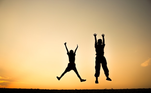 Premium Photo | Defocused silhouette of a boy is jumping over beautiful ...