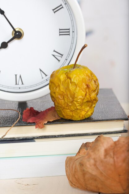 Premium Photo | Dehydrated shrivelled green apple on a working table