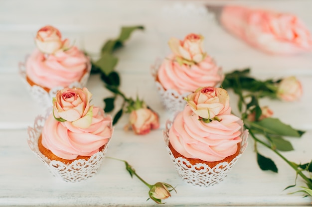 Premium Photo | Delicate tasty muffins with a pink cream decorated with ...