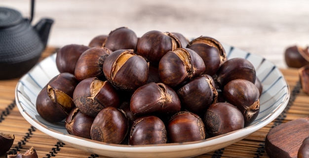 Premium Photo | Delicious cut roasted chestnuts with oil and sugar