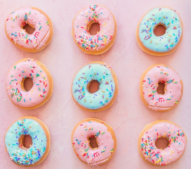 Download Free Photo Fresh Donuts On Chopping Board Near Package Over Pink Background