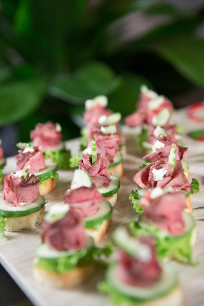 Free Photo | Delicious mini canapes with meat on buffet table