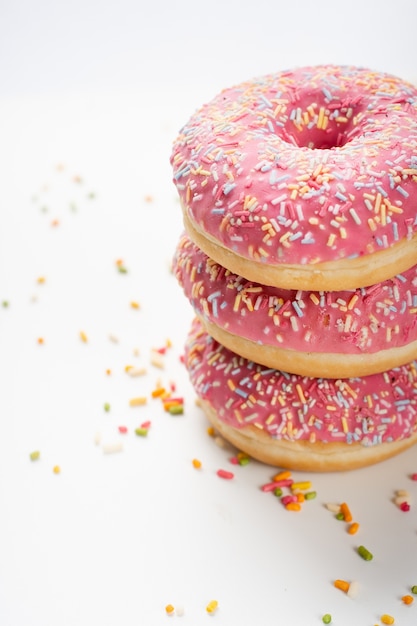 Free Photo | Delicious stacked doughnuts with glazing and sprinkles