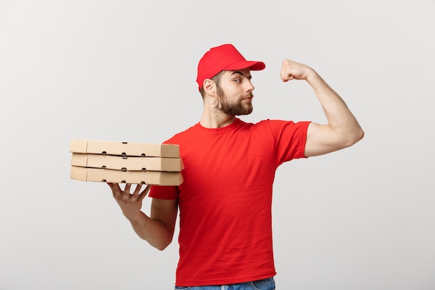 Premium Photo Delivery Concept Portrait Of Strong Handsome Delivery Man Flexing His Muscle