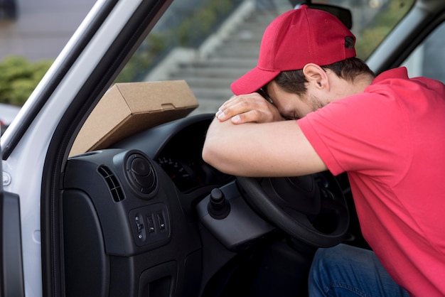 Free Photo | Delivery man in car resting