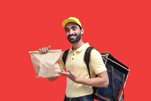 Premium Photo | Delivery man carrying backpack paper bag with takeaway ...