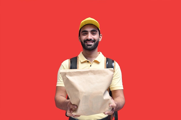 Premium Photo | Delivery man carrying backpack paper bag with takeaway ...