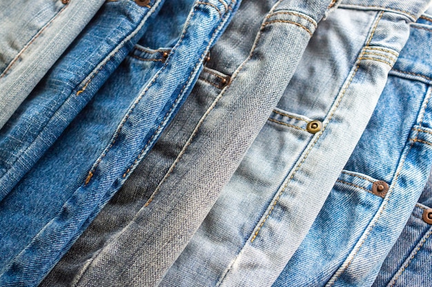Premium Photo | Denim jeans stacked together